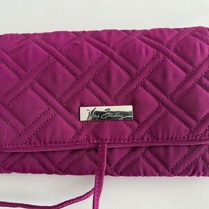 Purple quilted Vera Bradley travel case ties closed